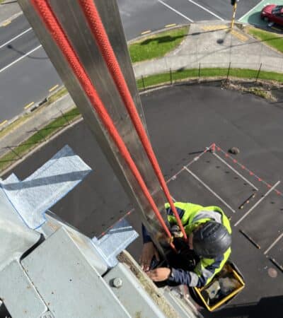 Technician applying Denso Viscotaq for corrosion protection using rope access by Connect Access in New Zealand